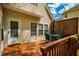Exterior view of wooden deck with dining table set, sun umbrella, and decorative lattice at 113 Glenmore Rd, Chapel Hill, NC 27516