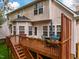 Wooden deck features table and chairs with decorative plants and an outdoor dining area at 113 Glenmore Rd, Chapel Hill, NC 27516