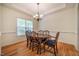 Formal dining room with hardwood floors, traditional chandelier and abundant natural light at 113 Glenmore Rd, Chapel Hill, NC 27516