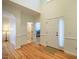 Welcoming entryway with light-colored walls, hardwood floors, and a white front door with side window at 113 Glenmore Rd, Chapel Hill, NC 27516