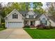 Charming two-story home with a well-manicured lawn, attached garage, and inviting front entrance at 113 Glenmore Rd, Chapel Hill, NC 27516