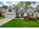 Beautiful two-story home with manicured lawn, attached garage, and decorative shutters at 113 Glenmore Rd, Chapel Hill, NC 27516