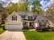 Charming home with well-manicured lawn, a two-car garage, and traditional architectural details at 113 Glenmore Rd, Chapel Hill, NC 27516