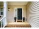 Inviting front porch with brick steps, a welcome mat, and decorative flower pots at 113 Glenmore Rd, Chapel Hill, NC 27516