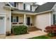 Inviting front porch with flower boxes, lush landscaping, and classic architectural details at 113 Glenmore Rd, Chapel Hill, NC 27516