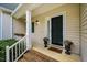 Inviting front porch featuring brick steps, potted plants, and stylish exterior lighting at 113 Glenmore Rd, Chapel Hill, NC 27516