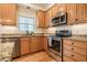 Modern kitchen with stainless steel appliances, custom cabinets, and granite countertops at 113 Glenmore Rd, Chapel Hill, NC 27516