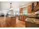 Open-concept kitchen flows into living area, featuring island with granite countertops at 113 Glenmore Rd, Chapel Hill, NC 27516