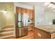 Kitchen featuring stainless steel refrigerator, custom cabinets, and hardwood flooring at 113 Glenmore Rd, Chapel Hill, NC 27516