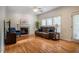 Spacious living room with a fireplace, hardwood floors, and plenty of natural light at 113 Glenmore Rd, Chapel Hill, NC 27516