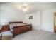 Spacious main bedroom featuring neutral carpet, ceiling fan, bedside tables with lamps and large bed at 113 Glenmore Rd, Chapel Hill, NC 27516