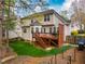 Backyard view of home featuring a wooden deck, lawn, and mature trees on a sunny day at 113 Glenmore Rd, Chapel Hill, NC 27516