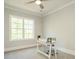 Bright home office with a large window, desk, and neutral decor creating a comfortable and productive workspace at 113 Tower Ridge Ln, Sanford, NC 27330
