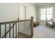 Upstairs landing area with a chair, bench and window at 113 Tower Ridge Ln, Sanford, NC 27330