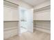 Spacious walk-in closet with open shelving on three sides and a view into a secondary room with storage at 113 Tower Ridge Ln, Sanford, NC 27330