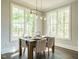 Bright dining room with large windows and a dining table set for a meal at 113 Tower Ridge Ln, Sanford, NC 27330