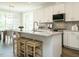 Bright kitchen with white cabinets, granite countertops, stainless steel appliances and a kitchen island with bar stools at 113 Tower Ridge Ln, Sanford, NC 27330