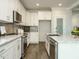 Bright kitchen with white cabinets, granite countertops and stainless steel appliances at 113 Tower Ridge Ln, Sanford, NC 27330