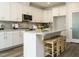 Bright kitchen with white cabinets, granite countertops, stainless steel appliances and a kitchen island with bar stools at 113 Tower Ridge Ln, Sanford, NC 27330