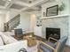 Bright living room with a decorative fireplace, built-in shelving, and a ceiling fan at 113 Tower Ridge Ln, Sanford, NC 27330