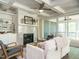 Bright living room with a decorative fireplace, built-in shelving, and a ceiling fan at 113 Tower Ridge Ln, Sanford, NC 27330