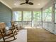 Relaxing screened porch with ceiling fan, wood floors, and view of the surrounding landscape at 113 Tower Ridge Ln, Sanford, NC 27330