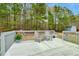 Spacious backyard deck with outdoor seating, perfect for relaxing and enjoying the serene wooded view at 114 Carriage Hill Dr, Stem, NC 27581