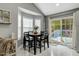 Cozy dining area featuring a view of the outdoor deck, seating for four, and ample natural light at 114 Carriage Hill Dr, Stem, NC 27581