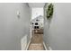 Inviting hallway showcasing hardwood floors leading to a cozy living room with a fireplace at 114 Carriage Hill Dr, Stem, NC 27581