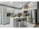 Bright kitchen featuring stainless steel appliances, a center island, and modern white cabinets at 114 Carriage Hill Dr, Stem, NC 27581