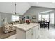 Open living space boasts vaulted ceilings, great natural light, and flows seamlessly into dining area at 114 Carriage Hill Dr, Stem, NC 27581