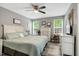 Relaxing main bedroom features neutral tones, a ceiling fan, and plenty of natural light at 114 Carriage Hill Dr, Stem, NC 27581