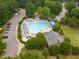Aerial view of the community pool and surrounding area with lounge chairs and seating at 120 Cypress View Way, Apex, NC 27502