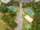 Aerial view of tennis courts and grounds with walking paths and greenery within the community at 120 Cypress View Way, Apex, NC 27502