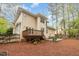 Exterior shot of the house from the backyard showcasing the deck and patio at 120 Cypress View Way, Apex, NC 27502