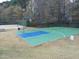 Outdoor basketball court featuring blue and green surfaces, nestled near a sand volleyball court at 120 Cypress View Way, Apex, NC 27502