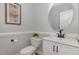 Powder room features a modern sink, round mirror, and gray walls at 120 Cypress View Way, Apex, NC 27502