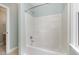 Clean bathtub with showerhead in a light-filled bathroom at 120 Cypress View Way, Apex, NC 27502