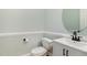 Well-lit half bath with white vanity, modern fixtures, and round mirror at 120 Cypress View Way, Apex, NC 27502