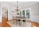 Dining room with hardwood floors, chandelier, and glass doors that open to the exterior at 120 Cypress View Way, Apex, NC 27502