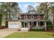Charming two-story home with a welcoming front porch and well-maintained lawn surrounded by mature trees at 120 Cypress View Way, Apex, NC 27502
