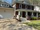 A delightful home with a charming front porch, complemented by a two-car garage and a well-kept front yard at 120 Cypress View Way, Apex, NC 27502