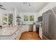 Bright kitchen features stainless steel appliances, granite countertops, and hardwood floors at 120 Cypress View Way, Apex, NC 27502