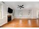 Beautiful living room with a fireplace, large windows, and gleaming hardwood floors at 120 Cypress View Way, Apex, NC 27502