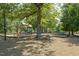 Community playground with swings, slides, and a picnic table set on mulch, providing recreational space at 120 Cypress View Way, Apex, NC 27502
