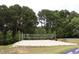 Community sand volleyball court with net and border, perfect for outdoor recreation and games at 120 Cypress View Way, Apex, NC 27502