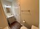 A well lit bathroom featuring a modern vanity, with a tiled floor, with tan painted walls at 1204 Amberstone Dr, Knightdale, NC 27545