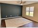 Spacious bedroom featuring a ceiling fan and hardwood floors with a neutral accent wall at 1204 Amberstone Dr, Knightdale, NC 27545