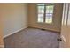 Bedroom with neutral walls and carpet, featuring a large window that floods the room with natural light at 1204 Amberstone Dr, Knightdale, NC 27545
