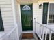 Welcoming front entry features a vibrant green door with a half-moon window at 1204 Amberstone Dr, Knightdale, NC 27545